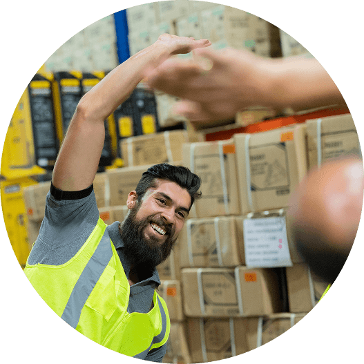 A man in a warehouse setting doing stretching exercises