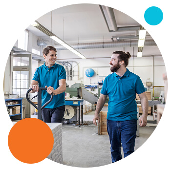 HP circle - capacity profiling Photo of 2 men in a warehouse setting smiling at each other